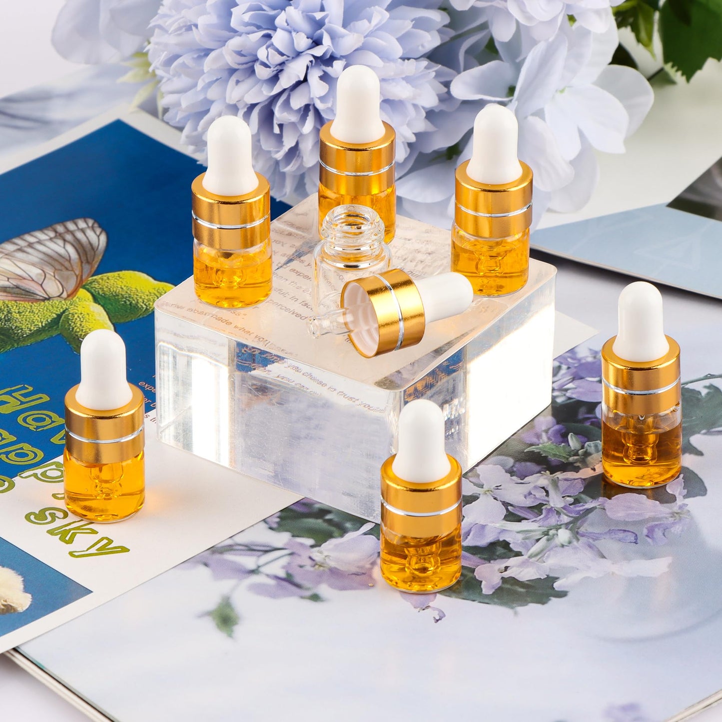 Comrzor 100 Pack 1ml Clear Glass Dropper Bottles with 4 Pcs Plastic Droppers, Mini Sample Dropper Bottles for Essential Oils Perfume Cosmetic Liquid, Empty Travel Sample Vials with Gold Cap